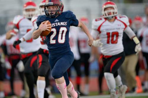 Chris Detrick  |  The Salt Lake Tribune
Herriman's Brig Rush (20) runs for a touchdown on the opening kickoff of the game during the game at Herriman High School Friday October 3, 2014.