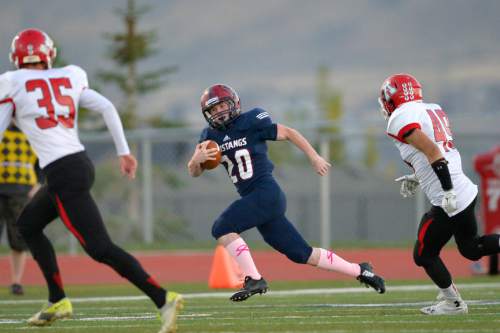 Chris Detrick  |  The Salt Lake Tribune
Herriman's Brig Rush (20) runs past American Fork's Jacob Whitehead (35) and American Fork's Brandon Bowen (49) for a touchdown on the opening kickoff of the game during the game at Herriman High School Friday October 3, 2014.