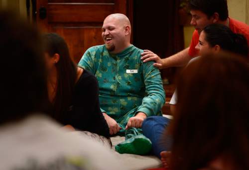 Scott Sommerdorf   |  The Salt Lake Tribune
Tim Longwell laughs as he describes his St. Patrick's Day-themed onesie during a "cuddle party" - a regular meet-up that happens in Utah, where strangers get together and cuddle in a nonsexual way, Friday, July, 31, 2015. Doug Roberts is at right.
