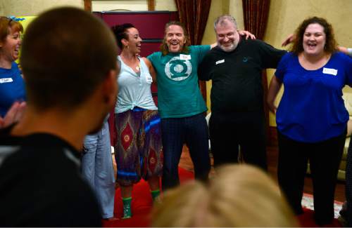 Scott Sommerdorf   |  The Salt Lake Tribune
Facilitator Rick Priddis leads the group in song at the end of "cuddle party" - a regular meet-up that happens in Utah, where strangers get together and cuddle in a nonsexual way, Friday, July, 31, 2015.