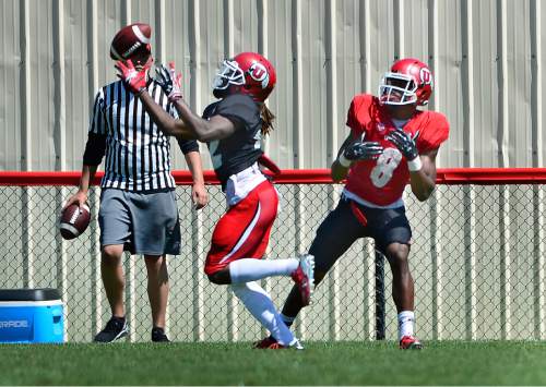Scott Sommerdorf   |  The Salt Lake Tribune
A Utah defensive back picked off this pass intended for Utah WR/RB Bubba Poole during practice, Saturday, August 15, 2015.