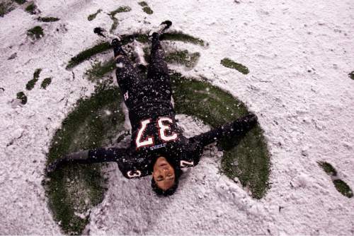 Trent Nelson  |  The Salt Lake Tribune
Hurricane's Joseph Takau makes a snow angel on the field after Hurricane defeated Desert Hills 21-0 in the 3A State Championship high school football game at Rice-Eccles Stadium in Salt Lake City, Utah, Friday, November 18, 2011.