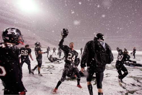 Trent Nelson  |  The Salt Lake Tribune
Hurricane's Tyson Long (24) and teammates celebrate in the snow after they defeated Desert Hills 21-0 in the 3A State Championship high school football game at Rice-Eccles Stadium in Salt Lake City, Utah, Friday, November 18, 2011.