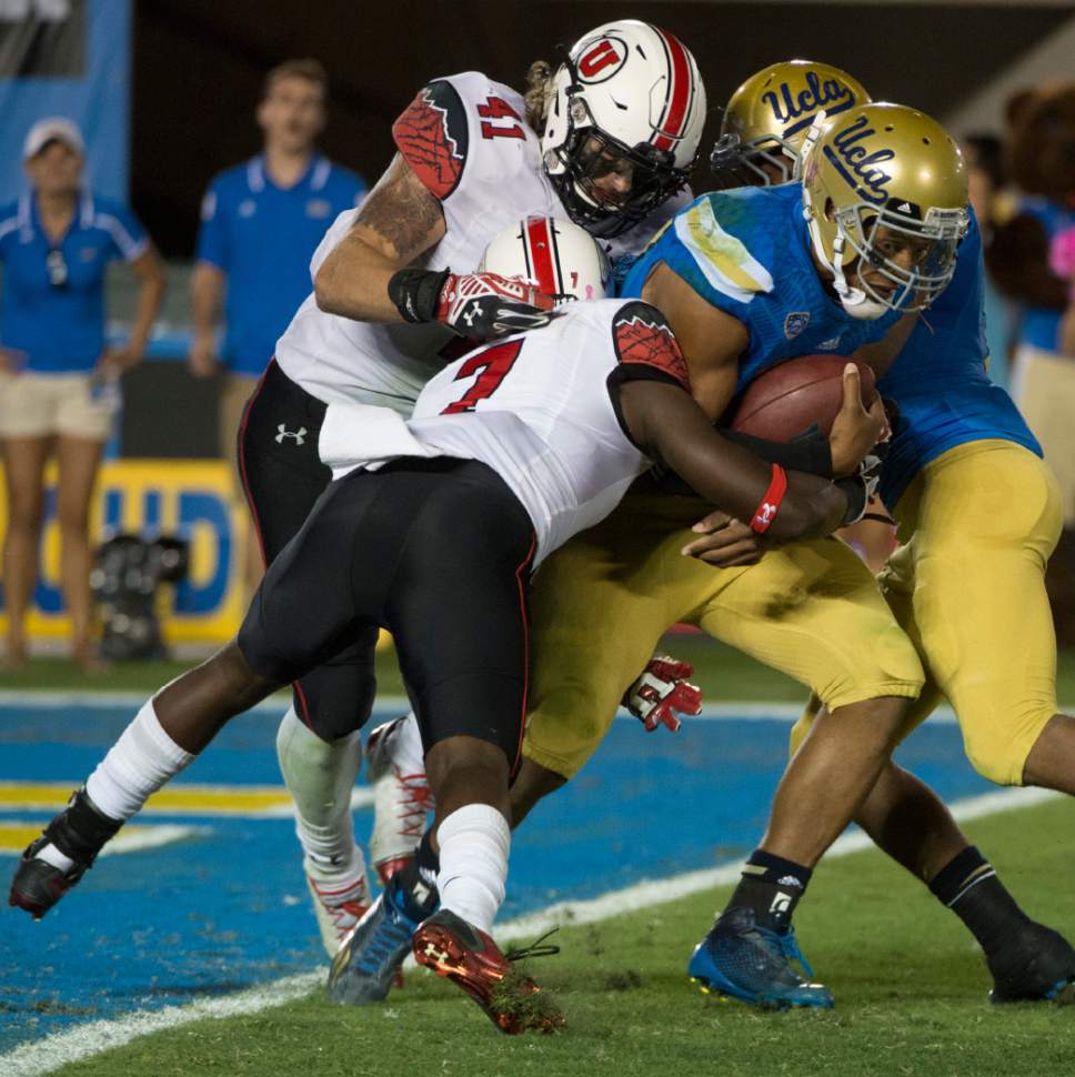 Rick Egan  |  The Salt Lake Tribune

Utah linebacker Jared Norris (41) and  Utah Utes defensive back Andre Godfrey (7) sack UCLA Bruins quarterback Brett Hundley (17) near the end zone the third play in a row, in Pac 12 action, Utah vs. UCLA,at the Rose Bowl, Saturday, October 4, 2014