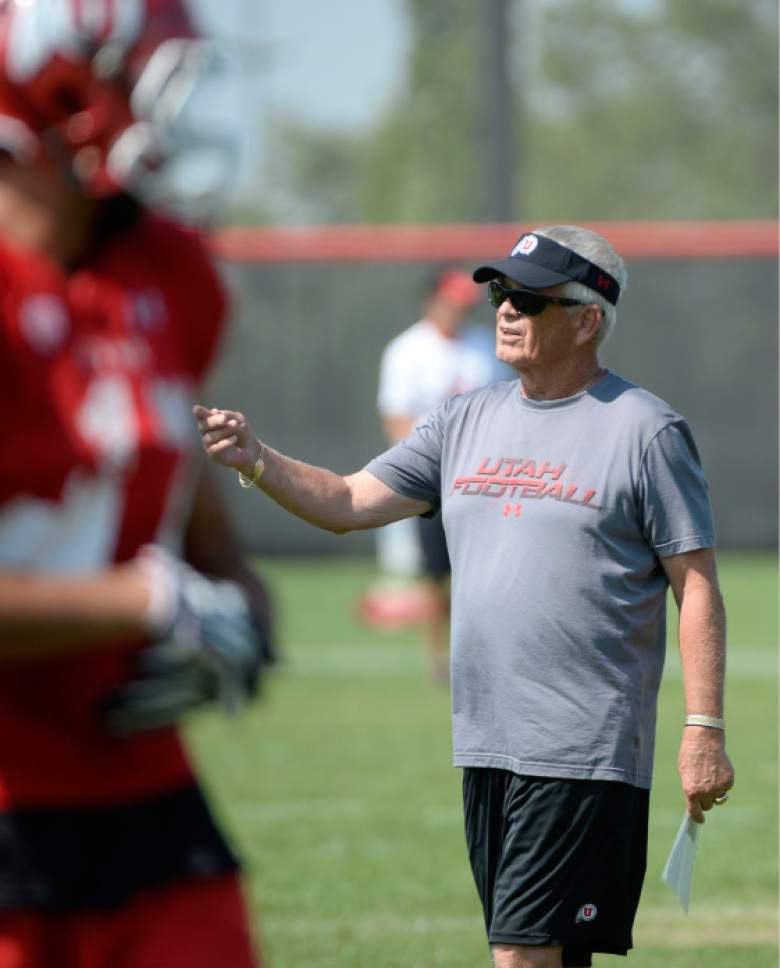 Al Hartmann  |  The Salt Lake Tribune
Assistant head coach Dennis Erickson runs the running backs during practice Monday August 17.