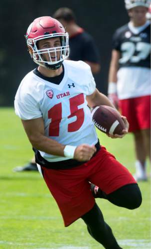 Steve Griffin  |  The Salt Lake Tribune

University of Utah quarterback Chase Hansen runs the ball during first day of fall football camp at the University of Utah baseball field in Salt Lake City, Thursday, August 6, 2015.  l