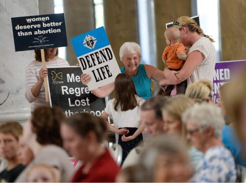 Francisco Kjolseth | The Salt Lake Tribune
Shannon Spencer, center, hands out pro-life posters as people gather at the Utah Capitol as part of the "Women Betrayed" rally on Wednesday, Aug. 19, in support to Gov. Gary Herbert's recent decision to remove the state from federal funding of Planned Parenthood.