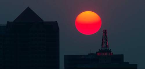 Steve Griffin  |  The Salt Lake Tribune

The sun glows orange as it sets over the Salt Lake City skyline Tuesday, August 18, 2015. Smoke from wild fires in California is contributing to the hazy conditions in the Salt Lake valley.