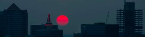 Steve Griffin  |  The Salt Lake Tribune

The sun glows orange as it sets over the Salt Lake City skyline Tuesday, August 18, 2015. Smoke from wild fires in California is contributing to the hazy conditions in the Salt Lake valley.