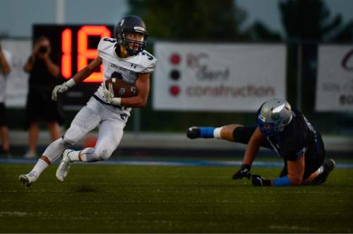 Scott Sommerdorf   |  The Salt Lake Tribune
Corner Canyon DB Nate Cutler runs with an interception during first half play. Pleasant Grove held a 28-19 4th quarter lead over Corner Canyon in Pleasant Grove, Friday, August 20, 2015.