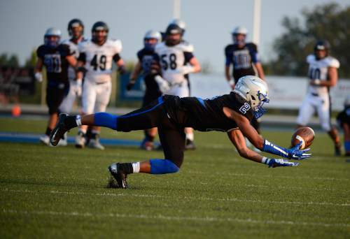 Scott Sommerdorf   |  The Salt Lake Tribune
Pleasant Grove WR Malik Overstreet dives for this catch during first half play. The Vikings held 28-19 4th quarter  lead over Corner Canyon in Pleasant Grove, Friday, August 20, 2015.