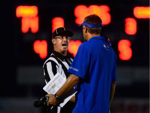 Scott Sommerdorf   |  The Salt Lake Tribune
Pleasant Grove head coach Les Hamilton has a conversation with line judge Troy Cullimore during second half play. The Vikings held a 21-19 3rd quarter lead over Corner Canyon in Pleasant Grove, Friday, August 20, 2015.