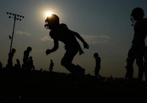 Scott Sommerdorf   |  The Salt Lake Tribune
Corner Canyon players practice prior to their matchup with the Pleasant Grove Vikings in Pleasant Grove, Friday, August 20, 2015.