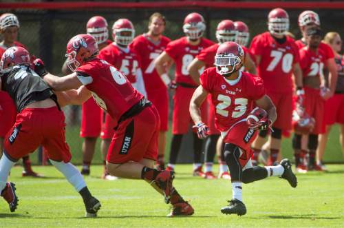 University of Utah running back Devontae Booker follows his blockers as he races up field during NCAA football camp, Thursday, Aug. 6, 2015 at the University of Utah  in Salt Lake City. (Steve Griffin/The Salt Lake Tribune via AP) DESERET NEWS OUT; LOCAL TELEVISION OUT; MAGS OUT; MANDATORY CREDIT