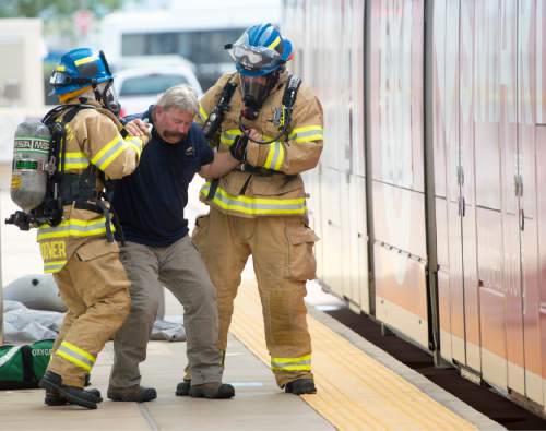 Rick Egan  |  The Salt Lake Tribune

Salt Lake Fire Fighters treat a victim during a terrorist attack response drill by UTA at the TRAX station at the Salt Lake City Airport, Wednesday, August 12, 2015.