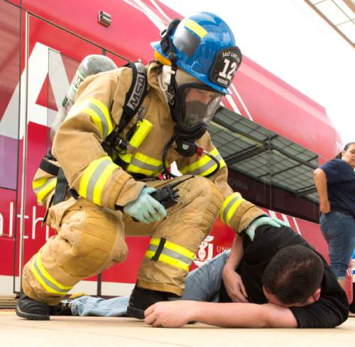 Rick Egan  |  The Salt Lake Tribune

Salt Lake Fire Fighters treat victims during a terrorist attack response drill by UTA at the TRAX station at the Salt Lake City Airport, Wednesday, August 12, 2015.