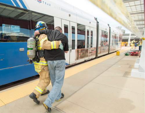 Rick Egan  |  The Salt Lake Tribune

Salt Lake Fire Fighters treat victims during a terrorist attack response drill by UTA at the TRAX station at the Salt Lake City Airport, Wednesday, August 12, 2015.