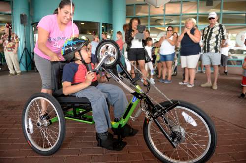 Al Hartmann  |  The Salt Lake Tribune
Jonathan Cardenas tries out his new adaptive bike at Shriners Hospital for Children in Salt Lake City Sunday August 23. He was one of four children to receive a bike, purchased by the Shriners with proceeds from their annual "Kruisers for Kids" car show fundraiser.