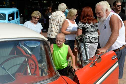 Al Hartmann  |  The Salt Lake Tribune
Jacob Larsen, 10, (center) checks out interior of Reg Bennion's 1956 Chevy Bel Air at Shriners Hospital for Children in Salt Lake City on Sunday, Aug. 23. Classic car owners were at the hospital to deliver a $21,238 check -- proceeds from their annual Kruisers for Kids car show fundraiser.