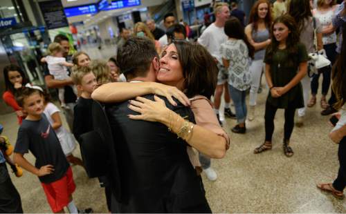 Francisco Kjolseth | The Salt Lake Tribune
Tammy Ogden of Sandy, Utah is overcome with emotion as she greets her son Taylor, 20, arriving at Salt Lake International Airport after serving a mission in Santiago Chile. A bumper crop of LDS missionaries returning due to the age-change back in 2012, is making it  challenging for Utah's universities to handle.