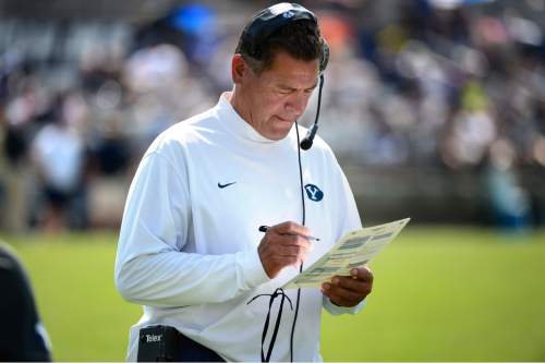 Scott Sommerdorf   |  The Salt Lake Tribune
BYU offensive coordinator Robert Anae checks his list of plays during practice, Saturday, August 22, 2015.