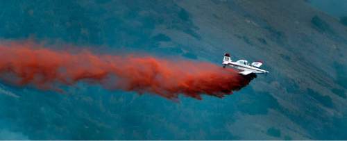 Rick Egan  |  The Salt Lake Tribune

A plane drops fire retardant on a fire in the mountains southeast of Payson, Monday, August 24, 2015.