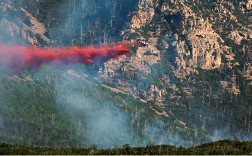 Rick Egan  |  The Salt Lake Tribune

A plane drops fire retardant on a fire in the mountains southeast of Payson, Monday, August 24, 2015.