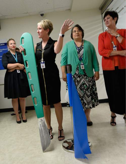 Francisco Kjolseth | The Salt Lake Tribune
Nancy Bardugon, RN, MSN and System Simulation Director, wields an oversized scalpel following the ribbon cutting for Intermountain Healthcare's opening of the state's largest and most advanced medical simulation center at LDS Hospital in Salt Lake City. The center is equipped with advanced simulation technology that allows staff the opportunity to develop and practice physical skills, critical thinking, decision-making, collaboration, and communication in a safe, realistic environment.