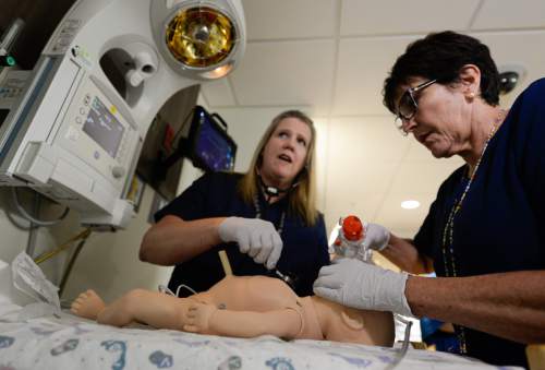 Francisco Kjolseth | The Salt Lake Tribune
New born intensive care nurses, Luann Westerman, left, and Mary Jane McGregor run through a new born delivery scenario as Intermountain Healthcare shows off the stateís largest and most advanced medical simulation center at LDS Hospital in Salt Lake City. The center is equipped with advanced simulation technology that allows staff the opportunity to develop and practice physical skills, critical thinking, decision-making, collaboration, and communication in a safe, realistic environment.