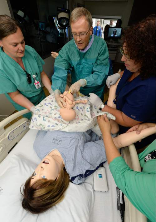 Francisco Kjolseth | The Salt Lake Tribune
Delivery nurse Kendra Michaelis, Dr. Doug Richards, and RN Melissa Baker, from left, perform a simulation birth as Intermountain Healthcare shows off their new medical simulation center at LDS Hospital in Salt Lake City. The center is equipped with advanced simulation technology that allows staff the opportunity to develop and practice physical skills, critical thinking, decision-making, collaboration, and communication in a safe, realistic environment.