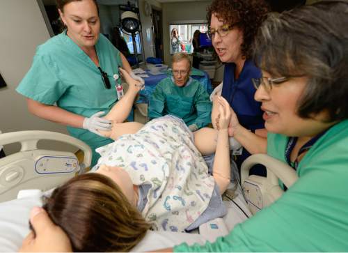 Francisco Kjolseth | The Salt Lake Tribune
Delivery nurse Kendra Michaelis, Dr. Doug Richards, RN Melissa Baker and Lisa Hubert, from left, perform a simulation birth as Intermountain Healthcare shows off their new medical simulation center at LDS Hospital in Salt Lake City. The center is equipped with advanced simulation technology that allows staff the opportunity to develop and practice physical skills, critical thinking, decision-making, collaboration, and communication in a safe, realistic environment.