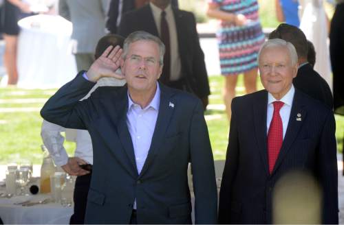 Al Hartmann  |  The Salt Lake Tribune
Presidential candidate Jeb Bush, left, with Utah Senator Orrin Hatch attends a fundraiser lunch at John Price residence in Salt Lake City Tuesday August 25. Bush cups his hand to his ear, saying it was "a Reagan thing," to try and hear a reporters question on the other side of an ornanental security fence. Public and press were not invited into the luncheon. Paying donors only.