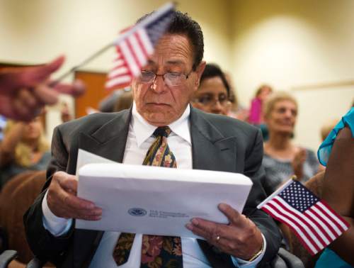 Steve Griffin  |  The Salt Lake Tribune

Alphonso DeLapaz, of Salt Lake City, looks at his certificate of citizenship as he joined 12 other immigrants who became American citizens during a naturalization ceremony at the South Jordan Library, Monday, August 24, 2015.