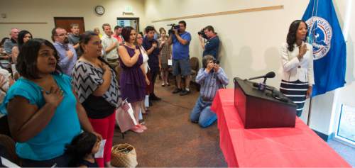 Steve Griffin  |  The Salt Lake Tribune

After 13 immigrants became American citizens during a  naturalization ceremony, Rep. Mia Love leads the group in the Pledge of Allegiance  at the South Jordan Library, Monday, August 24, 2015.  Love also told them of her family's immigration story and awarded each citizen their certificate of citizenship.