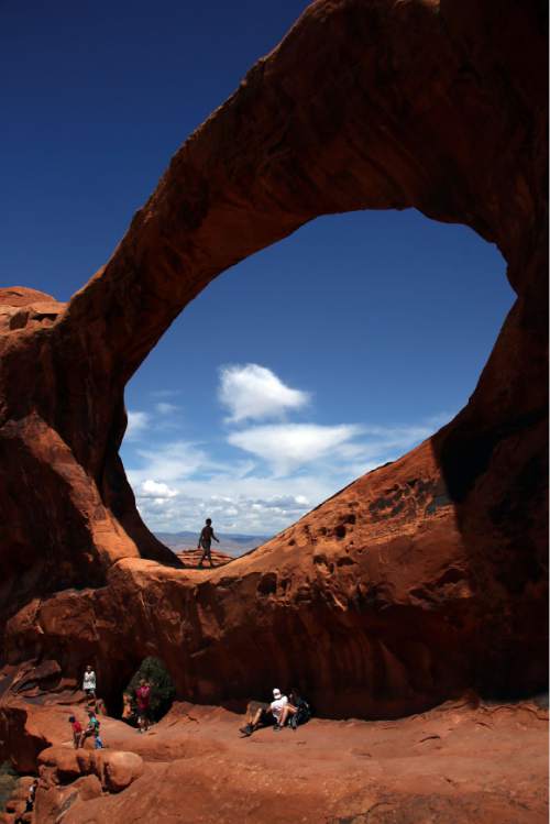 Francisco Kjolseth  |  The Salt Lake Tribune
Visitors to Arches National Park come from around the world as Double O Arch proves a popular destination.