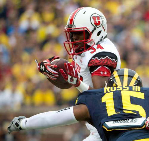 Jeremy Harmon  |  The Salt Lake Tribune

Utah's Bubba Poole (34) is tackled by Michigan's James Ross III (15) as the Utes face the Wolverines in Ann Arbor, Saturday, Sept. 20, 2014.