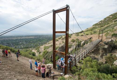 Steve Griffin  |  The Salt Lake Tribune

Builders, sponsors, supporters and Draper City officials cut the ribbon on the new pedestrian suspension bridge that spans 185 feet across Bear Canyon and connects the Bonneville Shoreline Trail in Draper, Tuesday, August 25, 2015.