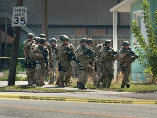 Alex Gallivan  |  Special to The Tribune
Early in the standoff, Unified Police SWAT officers get a view of the house, off camera to the right, where a suspect was heavily barricaded after a domestic dispute that turned into a standoff near 3300 South and 700 East, on Saturday, August 22, 2015. The suspect allegedly had fired at officers, and turned on the gas in the house.