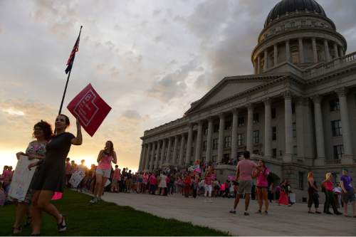Leah Hogsten  |  The Salt Lake Tribune
l-r Mia Ristovska and Noelle Cummings leave the rally. The Utah Capitol was covered in pink August 25, 2015 as Planned Parenthood Action Council of Utah held a community rally and proponents of the family- planning organization gathered. Governor Gary Herbert has said the money that would have gone to Planned Parenthood will be redirected to 26 health agencies in the state in 49 locations. Planned Parenthood estimates it will lose $75,000 of STD testing and more than $100,000 for educational programs.