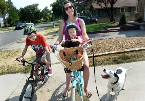 Scott Sommerdorf   |  The Salt Lake Tribune
Tina Escobar-Taft and her son Tony, 12, Seth, 2, and dog Lucy are about to go on a bike ride in their Salt Lake City neighborhood, Friday, August 21, 2015. 
--
Women and men who've received reproductive health care at Planned Parenthood clinics are not happy Gov. Gary Herbert is refusing to pass through federal money to the non-profit. Tina Escobar-Taft was a teenager when her mother first took her to Planned Parenthood for birth control pills, and she says the low-cost clinic helped her postpone becoming a mother until she was married and ready.