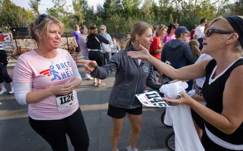 Scott Sommerdorf  |  The Salt Lake Tribune

Meri Brown, left, from the TV program "Sister Wives" carries on a conversation with a friend near the starting line of the 5K run to benefit Holding Out Help, a group that helps people leaving polygamy. The run started at 9 a.m. from Draper City Park, Saturday, September 22, 2012.