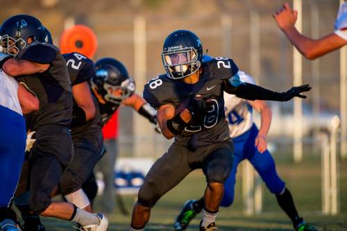 Chris Detrick  |  The Salt Lake Tribune
Summit Academy's Darrin Gethers (28) runs the ball during the game at Summit Academy High School Thursday August 27, 2015.