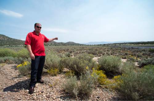 Rick Egan  |  The Salt Lake Tribune

Kelly Crane, district engineer, shows where a pipeline is planned in the Iron Springs area, near Cedar City, Friday, August 21, 2015