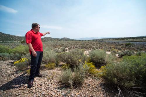 Rick Egan  |  The Salt Lake Tribune

Kelly Crane, district engineer, shows where a pipeline is planned in the Iron Springs area, near Cedar City, Friday, August 21, 2015