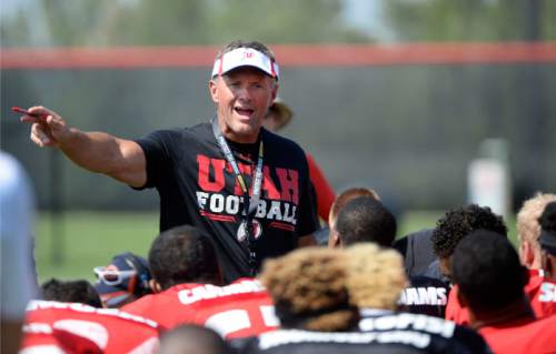 Al Hartmann  |  The Salt Lake Tribune
Ute head coach Kyle Whittingham gives some parting words to players at the end of practice Monday August 17.