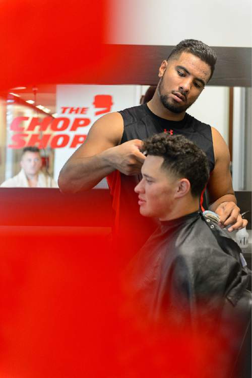 Trent Nelson  |  The Salt Lake Tribune
University of Utah football player Siale Fakailoatonga cuts the hair of his teammate, Evan Moeai, at the Spence and Cleone Eccles Football Center in Salt Lake City, Thursday August 27, 2015. The two are competing tight ends for the top spot on the depth chart, but they also are the team's go-to barbers. Their bond of cutting hair has brought them closer to their teammates, but also each other.