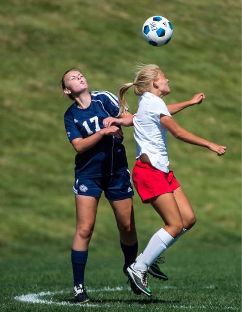 Chris Detrick  |  The Salt Lake Tribune
Woods Cross' Rachel Cole (17) and East's Sami Black (7) go for the ball during the game at East High School Thursday August 27, 2015.