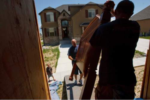Trent Nelson  |  Tribune File Photo
Movers unload a bed frame at a home in Saratoga Springs. Newly released census numbers provides statistics about residents moving into and out of Utah metro areas.