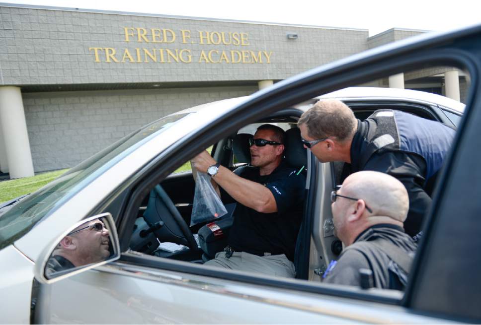 Francisco Kjolseth | The Salt Lake Tribune
After hiding "contraband" in a car Daniel Gordon, center, points out locations where Dirk Wilkinson, bottom, and Dan Jorgensen missed checking as Adult Probation and Parole officers with the department of correction run through drills at the Fred House Academy at the point of the mountain next to the prison administration building. Though the prison is moving to Salt Lake City, there is no current plan to move these two buildings.