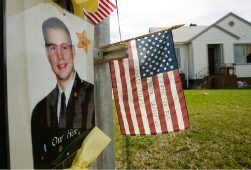 Leah Hogsten  |  The Salt Lake Tribune

Above, the telephone pole outside the 37th Street home in S. Ogden is decorated with Army Staff Sgt. Kurt Curtiss' photo and a flag that another S. Ogden resident placed there thanking Curtiss for his service.  South Ogden native, Army Staff Sgt. Kurt Curtiss was on a recovery mission at a hospital with his unit when he was caught in crossfire and killed, said his sister, Lynn Burr. Curtiss has lived in both Utah and Arizona. He served two tours of duty in Iraq before being transferred to Fort Richardson in Alaska. He was deployed to Afghanistan last year, and had been home for a visit about a month ago.